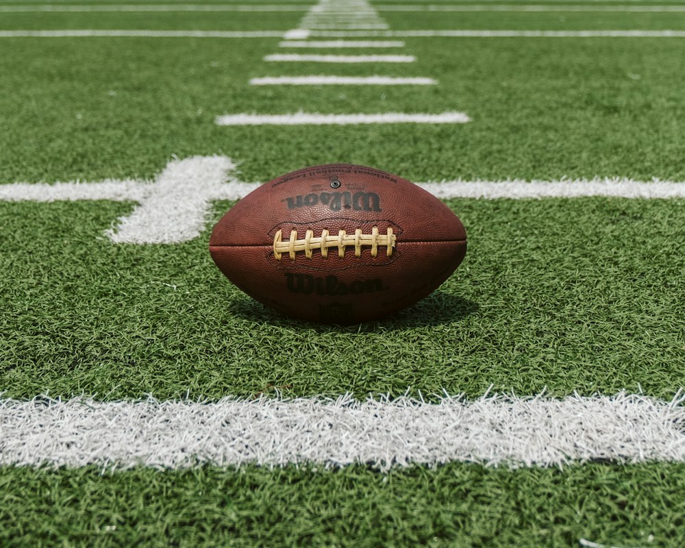 Baseball glove and ball on field